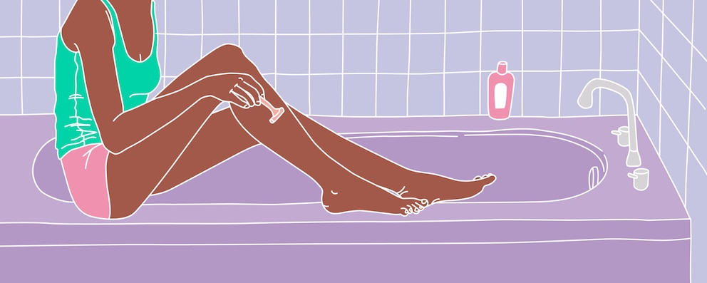 A woman sitting on her bathtub and shaving her legs