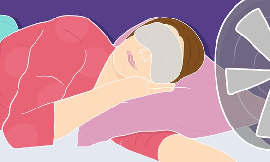 Menopausal woman sleeping in front of a fan wearing an eye mask