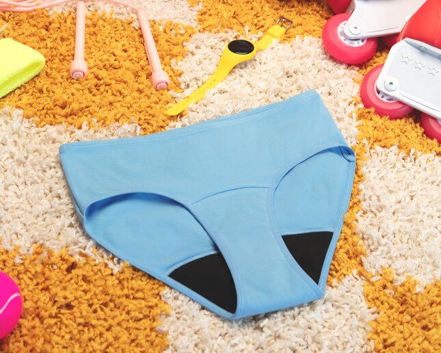 Blue period pants on yellow carpet